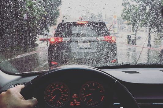 A driver in traffic on a rainy day