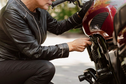 A woman checking her motorcycle before going for a ride